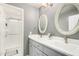 Bathroom showcasing double sinks with decorative mirrors and a glass-enclosed shower at 2701 E Lockwood St, Mesa, AZ 85213