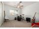 Neutral bedroom with a ceiling fan, window, and musical instruments, perfect for hobbyists at 2701 E Lockwood St, Mesa, AZ 85213