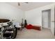 Bedroom featuring a ceiling fan, carpeted floor and assorted musical instruments at 2701 E Lockwood St, Mesa, AZ 85213