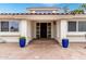 Welcoming home entrance with a decorative front door, colorful planters, and red brick paver walkway at 2701 E Lockwood St, Mesa, AZ 85213
