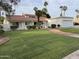 Inviting single-story home with a red-tiled roof, lush lawn, and charming brick pathway leading to the front door at 2701 E Lockwood St, Mesa, AZ 85213