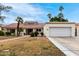 Charming single-story home with a red tile roof, well-manicured landscaping, and a two-car garage at 2701 E Lockwood St, Mesa, AZ 85213