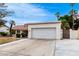 Two-car garage with a wide driveway and partial landscaping near the exterior at 2701 E Lockwood St, Mesa, AZ 85213
