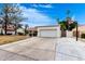 Two-car garage with a wide driveway and basketball hoop near the exterior at 2701 E Lockwood St, Mesa, AZ 85213