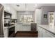 Modern kitchen featuring stainless steel appliances, a farmhouse sink, and plenty of natural light at 2701 E Lockwood St, Mesa, AZ 85213