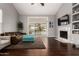 Bright living room with hardwood floors, a fireplace, and sliding glass doors to the outdoor space at 2701 E Lockwood St, Mesa, AZ 85213