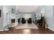Bright living room featuring a fireplace, piano, and plush rug for a cozy, inviting space at 2701 E Lockwood St, Mesa, AZ 85213