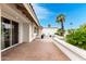 Charming brick patio area with white exterior walls, potted plants, and ample space for entertaining at 2701 E Lockwood St, Mesa, AZ 85213