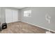 Bright bedroom featuring wood floors, a window, and a large closet at 2744 E John Cabot Rd, Phoenix, AZ 85032