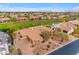 Expansive aerial view of a single-story home with lush backyard bordering a community green space at 2998 E Waterman Way, Gilbert, AZ 85297