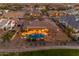 Aerial view of a backyard featuring a sparkling pool, covered patio, and lush landscaping with mature trees at 2998 E Waterman Way, Gilbert, AZ 85297