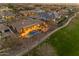Twilight aerial view of desert community home with lush landscaped backyard and putting green at 2998 E Waterman Way, Gilbert, AZ 85297