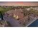 Aerial view of desert single Gathering home with 3-car garage and brick paved driveway at dusk at 2998 E Waterman Way, Gilbert, AZ 85297