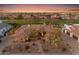 Stunning aerial view of an estate home with manicured landscaping near a golf course with a tile roof during a picturesque sunset at 2998 E Waterman Way, Gilbert, AZ 85297