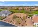 Aerial view showcasing the home's manicured landscaping, circular driveway, and tile roof in a neighborhood setting at 2998 E Waterman Way, Gilbert, AZ 85297