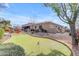 Inviting backyard featuring a putting green, outdoor seating, and a fire pit for relaxing evenings at 2998 E Waterman Way, Gilbert, AZ 85297