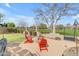 Backyard features an outdoor fire pit, putting green, patio furniture, and mature trees at 2998 E Waterman Way, Gilbert, AZ 85297