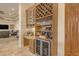 Built-in bar area with wine rack, glass storage, mini fridge, and granite countertop at 2998 E Waterman Way, Gilbert, AZ 85297