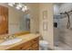 View of the renovated bathroom that features stone countertops and a tiled walk-in shower at 2998 E Waterman Way, Gilbert, AZ 85297