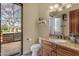 Bathroom with vanity and door to outdoor built-in gas grill and pool at 2998 E Waterman Way, Gilbert, AZ 85297