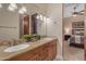 The bathroom has dual sinks with wooden cabinets, granite counters, and access to the bedroom at 2998 E Waterman Way, Gilbert, AZ 85297