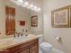 Well lit bathroom with a granite countertop, framed mirror, and classic fixtures at 2998 E Waterman Way, Gilbert, AZ 85297