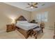 This bedroom offers a decorative bed frame and is equipped with a ceiling fan and a nearby workstation at 2998 E Waterman Way, Gilbert, AZ 85297