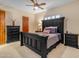 This bedroom is equipped with a ceiling fan and a dark wood bedroom set at 2998 E Waterman Way, Gilbert, AZ 85297