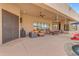 Spacious covered patio with ceiling fans, lounge area, and outdoor dining, ideal for relaxing and entertaining at 2998 E Waterman Way, Gilbert, AZ 85297