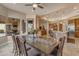Dining area featuring a long wooden table, seating for six, and views of the outdoor patio at 2998 E Waterman Way, Gilbert, AZ 85297