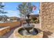 Outdoor fountain with three tiers, stone accents, and desert plants surrounding the landscape at 2998 E Waterman Way, Gilbert, AZ 85297