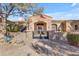 Charming stone house with arched entryway, gated courtyard, and decorative fountain at 2998 E Waterman Way, Gilbert, AZ 85297