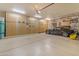 Well-organized garage featuring epoxy floors, custom cabinets, and ample space for vehicle storage and hobbies at 2998 E Waterman Way, Gilbert, AZ 85297