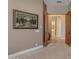Hallway with neutral carpet and a large art piece on the wall at 2998 E Waterman Way, Gilbert, AZ 85297