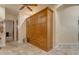 Hallway with full wall cabinet, tile floors, and access to other rooms at 2998 E Waterman Way, Gilbert, AZ 85297