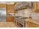 A gourmet kitchen features stainless steel appliances, granite counters, and custom cabinetry at 2998 E Waterman Way, Gilbert, AZ 85297