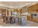 Gourmet kitchen featuring stone accents, custom cabinets, and a large center island with seating at 2998 E Waterman Way, Gilbert, AZ 85297