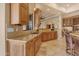 Well-lit kitchen with light wood cabinetry, granite countertops, and stainless steel sink at 2998 E Waterman Way, Gilbert, AZ 85297