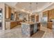 Gourmet kitchen with an island, granite counters, stainless appliances, and custom wood cabinetry at 2998 E Waterman Way, Gilbert, AZ 85297