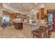 Bright, open kitchen with large island, stone accents, stainless appliances, and wood cabinetry at 2998 E Waterman Way, Gilbert, AZ 85297