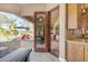 View from the kitchen, features wooden cabinets, and a large window viewing the pool and sunroom at 2998 E Waterman Way, Gilbert, AZ 85297