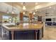 Open kitchen with granite countertops, stainless steel appliances, and island with sink at 2998 E Waterman Way, Gilbert, AZ 85297