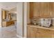 Kitchen prep area featuring light wood cabinets and granite countertops, with coffee accessories at 2998 E Waterman Way, Gilbert, AZ 85297