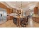 Spacious kitchen with granite counters, stainless appliances, custom cabinets, and barstool seating at 2998 E Waterman Way, Gilbert, AZ 85297