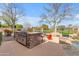 Outdoor kitchen with a built-in BBQ, stone surround, and a bar with comfortable seating at 2998 E Waterman Way, Gilbert, AZ 85297