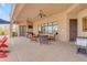 Spacious covered patio features outdoor seating, dining, barbecue, and ceiling fans for comfort at 2998 E Waterman Way, Gilbert, AZ 85297