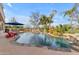 Resort-style pool featuring rock waterfalls, lush landscaping, and ample space for relaxation and entertainment at 2998 E Waterman Way, Gilbert, AZ 85297