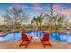 Relaxing pool area with waterfall features, lush landscaping, and comfortable lounge chairs at 2998 E Waterman Way, Gilbert, AZ 85297