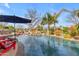 Beautiful pool area featuring rock waterfalls, lush landscaping, and comfortable seating for poolside relaxation at 2998 E Waterman Way, Gilbert, AZ 85297