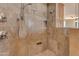 Close up on a tiled shower featuring dual shower heads, built-in shelves, and a stone floor at 2998 E Waterman Way, Gilbert, AZ 85297
